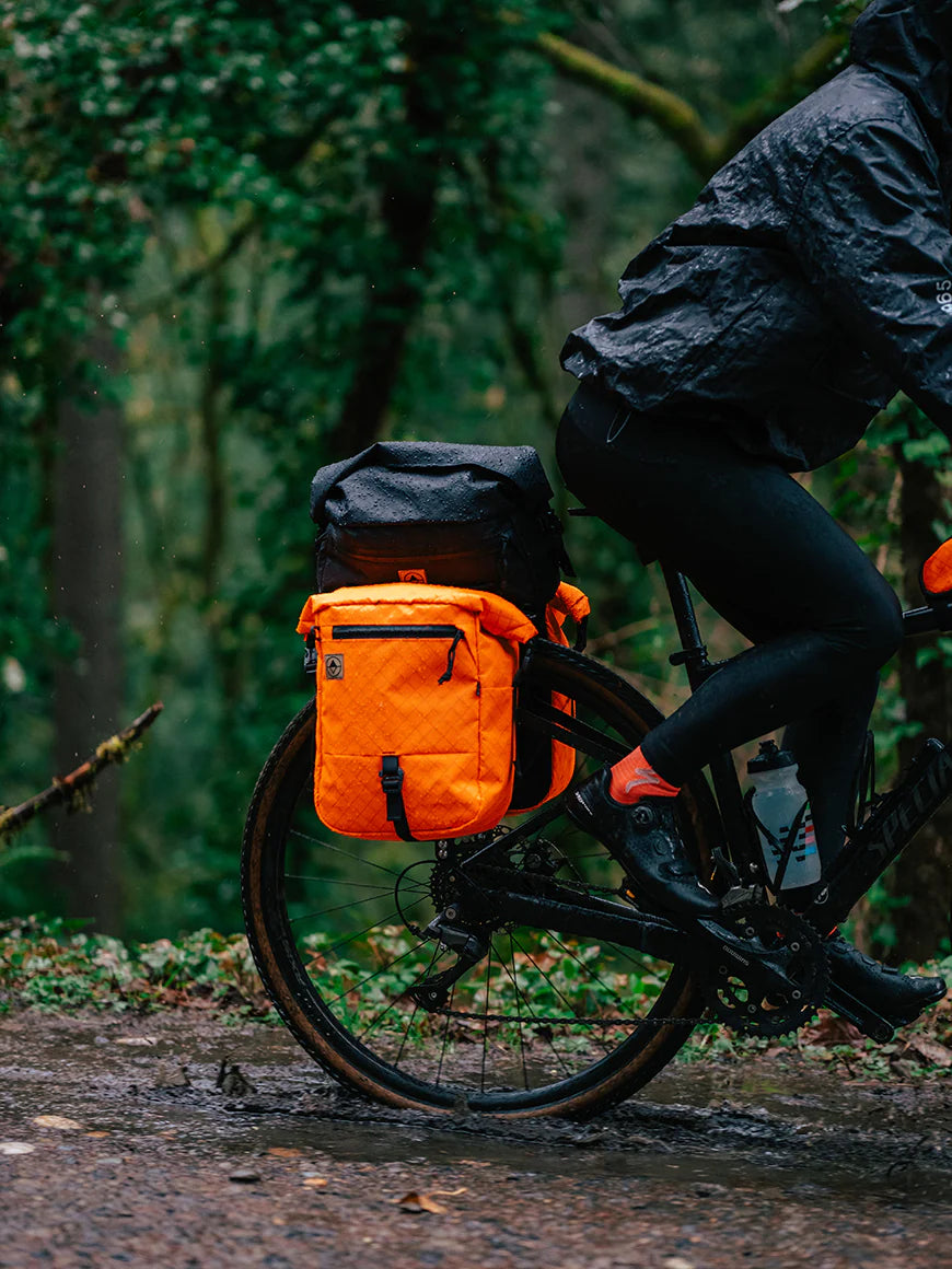 Cylist riding on a wet muddy pack with Bikepacking 澳洲5结果记录 panniers and trunk bag. | North St Bags - all-groups